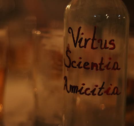 Bottle bearing the motto Virtus, Scientia, Amicitia